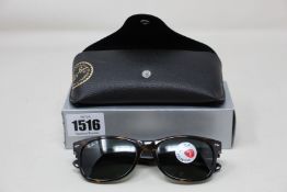 A pair of as new Ray Ban sunglasses.