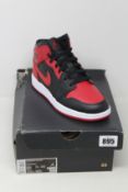 A pair of youths as new Nike Air Jordan 1 Mid (UK 5).