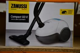 A new Zanussi Compact Go ll White, 750W, 1.5L, 5M automatic cord rewind vacuum cleaner.