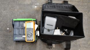 A case containing a Gossen Metrawatt Seculife ST Tester S3, a Fluke 287 True RMS Multimeter, a Hioki