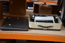 A pre-owned vintage Olympia typewriter (Some damage, item untested).