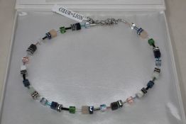 A boxed as new Coeur De Lion GeoCUBE Necklace with Swarovski crystals & gemstones in blue-green.