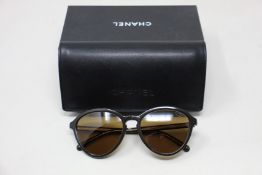 A pair of as new Chanel sunglasses.
