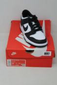 A pair of youths as new Nike Dunk Low (UK 3).