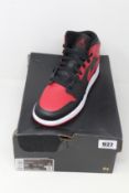 A pair of youths as new Nike Air Jordan 1 Mid (UK 6).