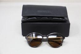 A pair of as new Chanel sunglasses.
