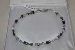 A boxed as new Coeur De Lion GeoCUBE Necklace with Swarovski crystals & gemstones in blue-green.