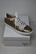 A pair of as new Guinea Camden bronze low top trainers (EU 41).