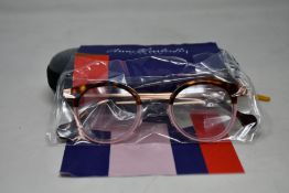 A pair of as new Anne & Valentin glasses frames with case.
