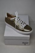 A pair of as new Guinea Camden bronze low top trainers (EU 41).