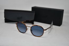 A pair of as new Persol sunglasses.