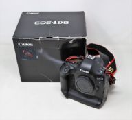 A pre-owned Canon EOS- X SLR Camera Body with two Canon battery packs, Canon charging dock, Neewer