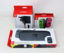 Three boxed as new official Nintendo Switch accessories to include; 1x neon green/pink joy-con pair,