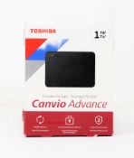 A boxed as new Toshiba Canvio Advance 1TB external storage drive in black.
