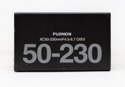 A boxed as new Fujiflim Fujinon XC 50-230mm f/4.5-6.7 OIS II Lens in Black.