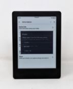 A pre-owned Kindle (8th Gen) in Black (Some cosmetic marks to casing).