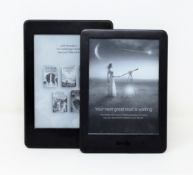 A pre-owned Kindle Paperwhite (7th Gen) in Black (Some damage to screen) and a pre-owned Kindle