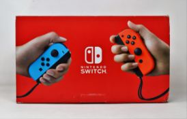 A pre-owned boxed Nintendo Switch neon games console with accessories (model: XKJ40028303035).
