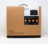 A boxed as new Synology DS418 4 Bay Desktop NAS Enclosure (Two pin plug included).