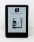 A pre-owned Kindle (7th Gen) in Black (Some cosmetic marks to casing).