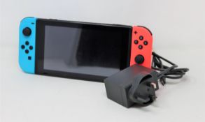 A pre-owned Nintendo Switch games console with neon joy-cons (includes charger) (no dock).