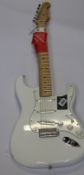 A Fender Player Series Stratocaster in white (Item has some minor damage).
