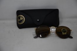 A pair of as new Ray Ban sunglasses.