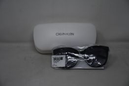 A pair of as new Calvin Klein sunglasses.