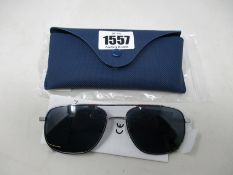 A pair of as new Lacoste sunglasses.