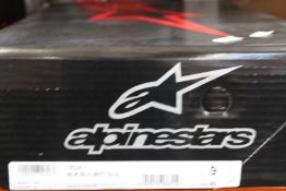 A pair of Alpinestars Tech 7 motocross boots in black, silver, white and gold (Size US 9 / EU 43).