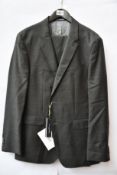 An as new Tommy Hilfiger suit in grey (EU 52).