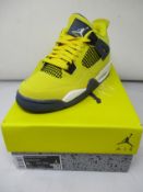 A pair of youths as new Nike Air Jordan 4 Retro in tour yellow (UK 4.5).