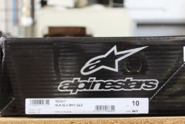 A pair of Alpinestars Tech 7 motocross boots in black, silver, white and gold (Size US 10 / EU 44.