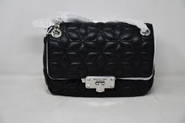 An as new Michael Kors Peyton bag in black.