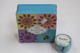 Twenty sets of four Moksha Premium Scented Candles.