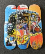 A set of three as new Jean-Michel Basquiat skull-print skateboards from The Skateroom.
