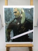 A Witcher picture signed by Henry Cavil certified by PSA/DNA.