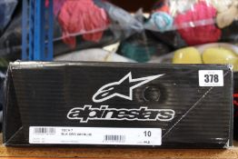 A pair of Alpinestars Tech 7 motocross boots in black, orange, white and blue (Size US 10 / EU 44.