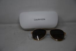 A pair of as new Calvin Klein sunglasses.