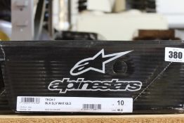 A pair of Alpinestars Tech 7 motocross boots in black, silver, white and gold (Size US 10 / EU 44.