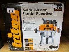 A Triton TRA001 2400W Dual Mode Precision Plunge Router.