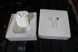 Fifty one unbranded headphones in charging cases.