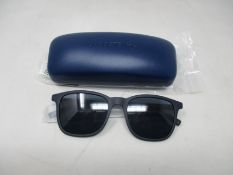 A pair of as new Lacoste sunglasses.