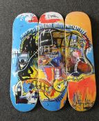 A set of three as new Jean-Michel Basquiat skull-print skateboards from The Skateroom.