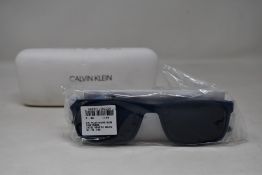 A pair of as new Calvin Klein sunglasses.
