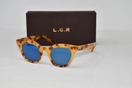 A pair of as new L.G.R. sunglasses.