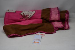 An as new Karen Mabon X Peter Rabbit woven raspberry blanket, part of a limited-edition capsule