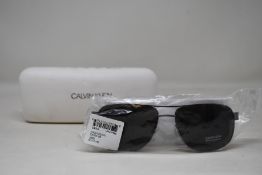 A pair of as new Calvin Klein sunglasses.