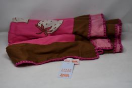 An as new Karen Mabon X Peter Rabbit woven raspberry blanket, part of a limited-edition capsule