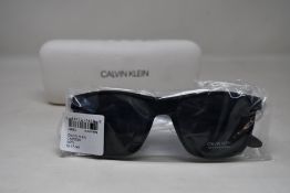 A pair of as new Calvin Klein sunglasses.